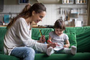 Mom and daughter using colored pencils on a coloring book.